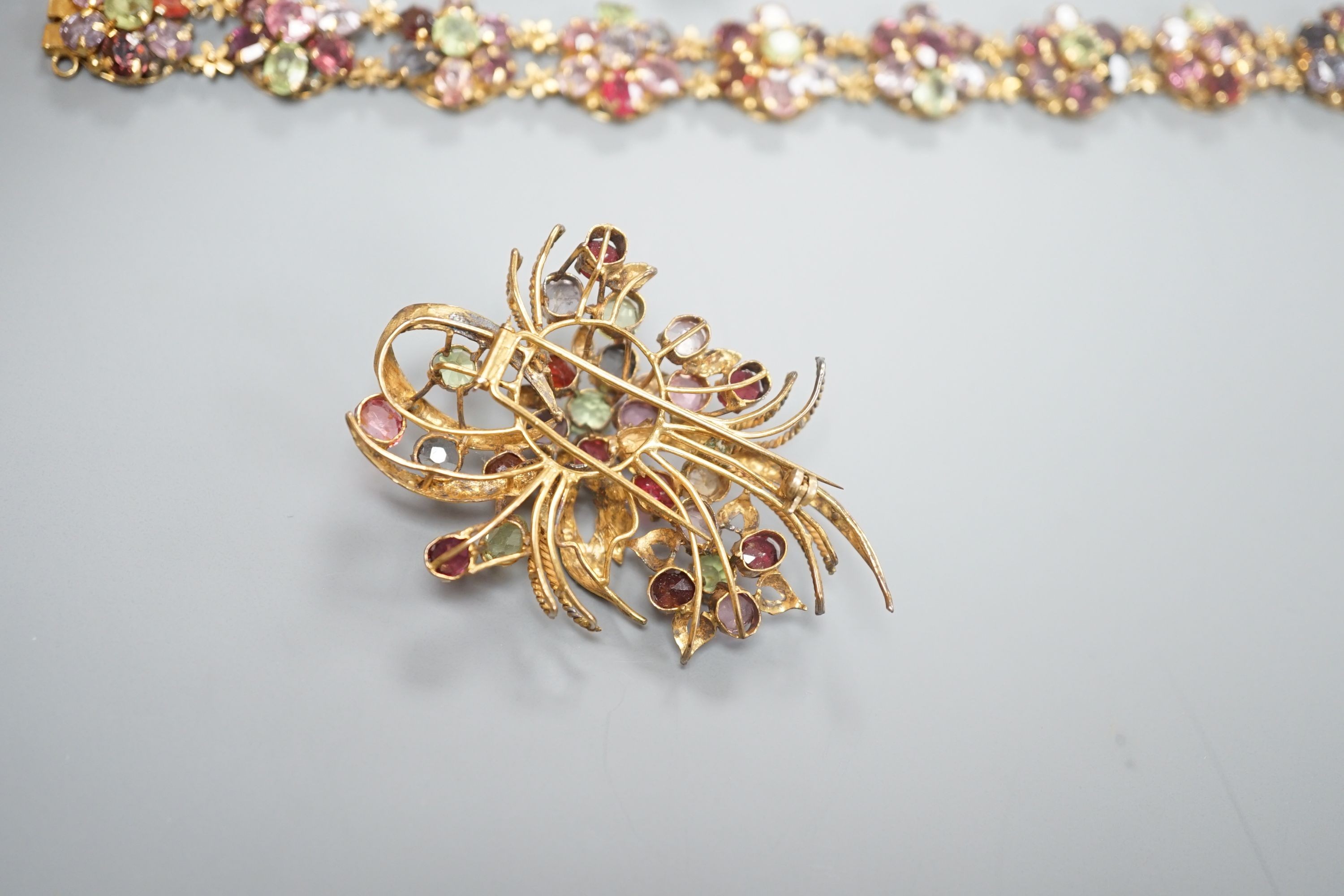 A gilt metal and coloured paste set bracelet and pair of earrings and a similar brooch, 6cm.
